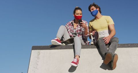 Friends at Skate Park with Masks Enjoying Summer Amid Pandemic