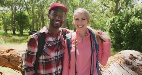 Smiling Diverse Couple Embracing During Park Hike