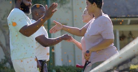 Doubles players shaking hands on residential tennis court, exchanging sportsmanship