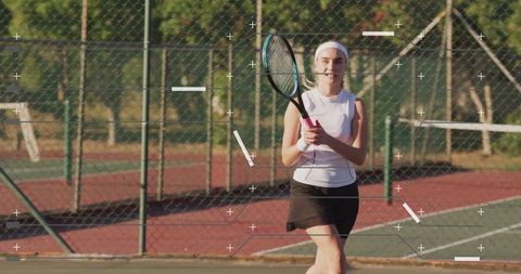 Female Tennis Player Prepares in Sporty Outfit on Outdoor Court