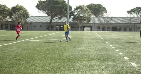 Youth soccer game on sunny field with team competition