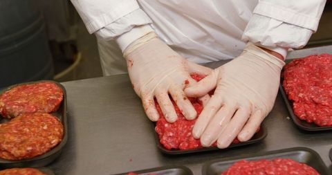 Butcher packing minced meat in supermarket