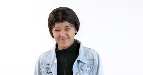 Confident Young Woman Smiling in Denim Jacket