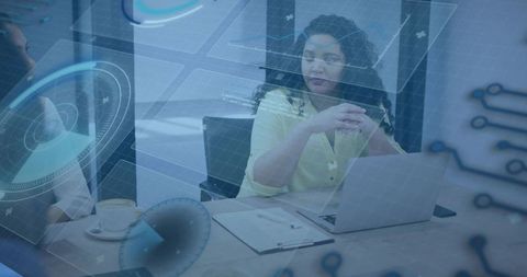 Female Leader Guiding Tech Team in Boardroom with Futuristic HUD Data Overlay and Laptop Collaborati