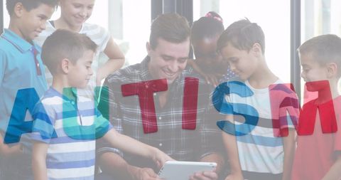 Teacher using tablet with diverse children in inclusive classroom