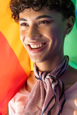 Joyful person celebrating pride with rainbow flag
