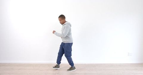 Energetic Dance Movement on Wooden Floor by Urban Dancer