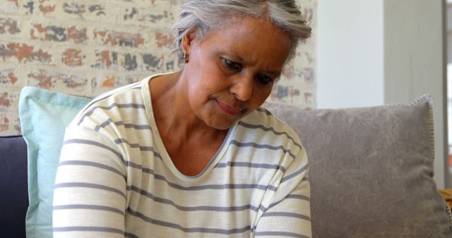 Senior Woman Deep in Thought Sitting on Couch at Home - Download Free Stock Images Pikwizard.com