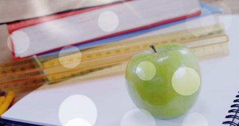 Literacy concept with green apple and school supplies