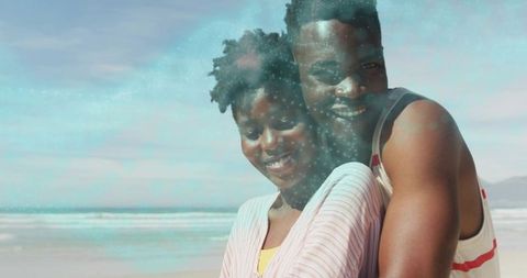 Couple Embracing on Ocean Shore Smiling Together During Sunny Romantic Beach Moment