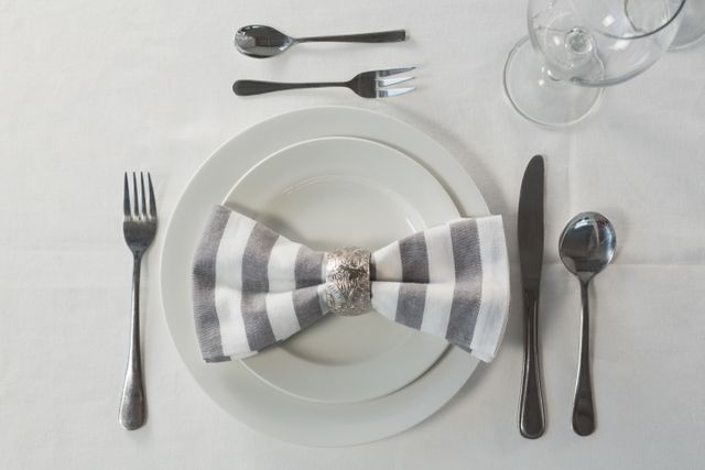 Overhead view of plate and cutlery set elegantly on a table