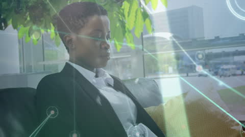 Focused Businesswoman Utilizing Technology in Modern Office