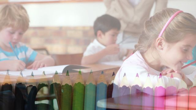 Diverse group of happy elementary school kids learning in a classroom, with a colorful crayons animation overlay. Ideal for education-related content, learning resources, school promotions, and child development themes.