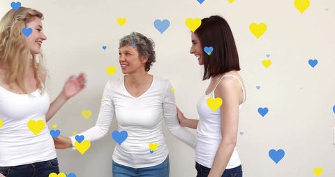 Inspirational Women Embracing with Digital Hearts Overlay