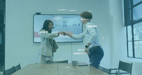 Business colleagues fist bumping during presentation with augmented reality overlay