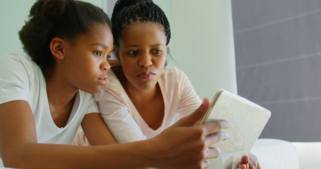 Mother and Daughter Using Digital Tablet Together at Home - Download Free Stock Images Pikwizard.com