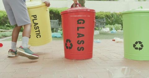 Child Sorting Colorful Recycling Bins in Park Teaching Waste Separation and Sustainability