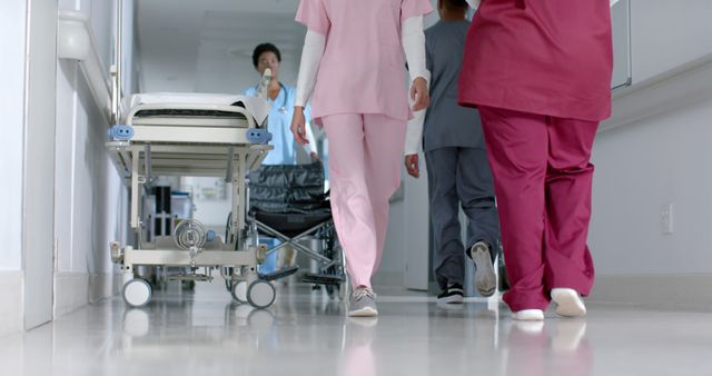 Healthcare Professionals Walking in Hospital Corridor Near Medical Equipment - Download Free Stock Images Pikwizard.com