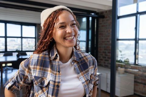 Smiling Professional Woman in Modern Loft Workspace
