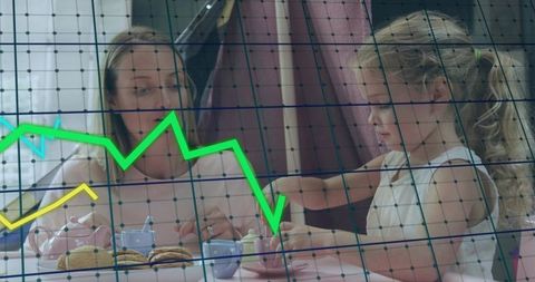 Mother and Daughter Sharing Tea with Declining Financial Graph Overlay