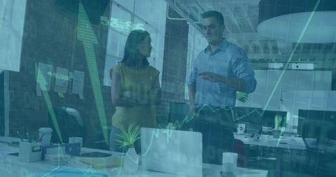 Colleagues Analyzing Financial Charts in Modern Workspace