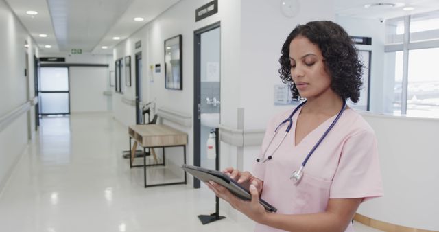 Medical Professional Using Tablet in Hospital Corridor - Download Free Stock Images Pikwizard.com