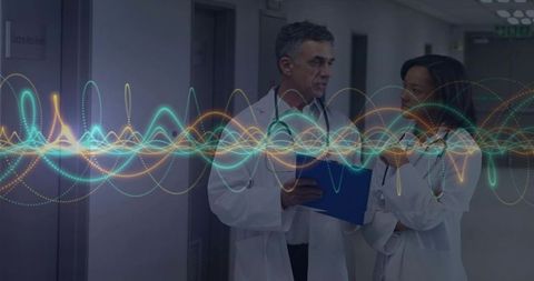 Doctors Collaborating in Hospital Corridor with Innovative Technology