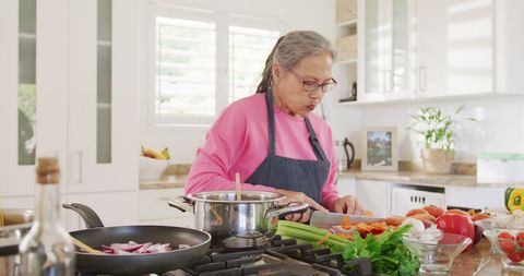 Senior Woman Cooking in Modern Kitchen Chopping Vegetables - Download Free Stock Images Pikwizard.com