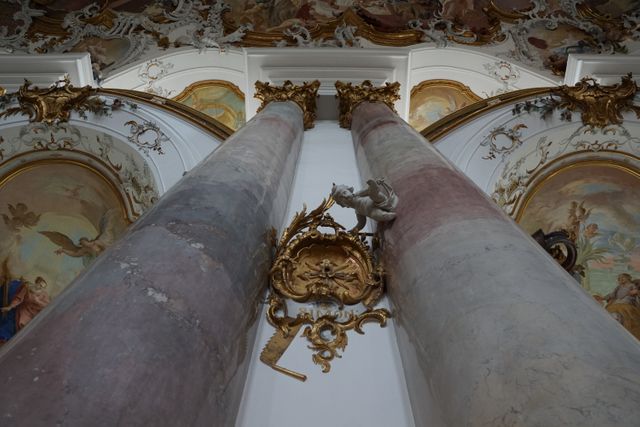 This stunning Baroque church interior showcases towering ornate columns and a beautifully decorative ceiling with frescoes. Suitable for projects on historical architecture, religious settings, or European art. Use for educational content, travel blogs, cultural documentaries, or church-related publications.