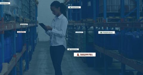 Young warehouse clerk reviewing inventory on digital tablet