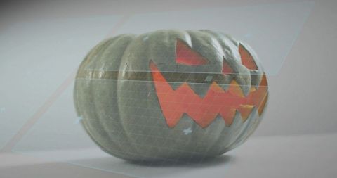 Holographic jack-o'-lantern glowing with geometric eyes and jagged mouth