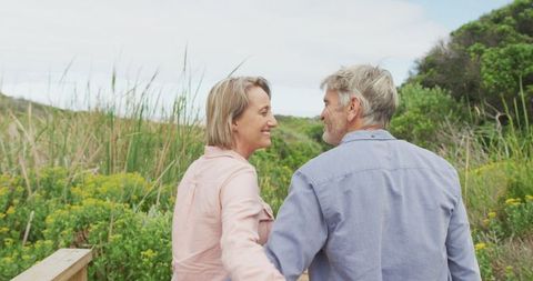 Joyful Senior Couple Walking Hand in Hand on Nature Path - Download Free Stock Images Pikwizard.com