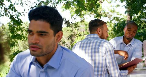 Business Team Outdoor Lunch Meeting in Sunny Garden