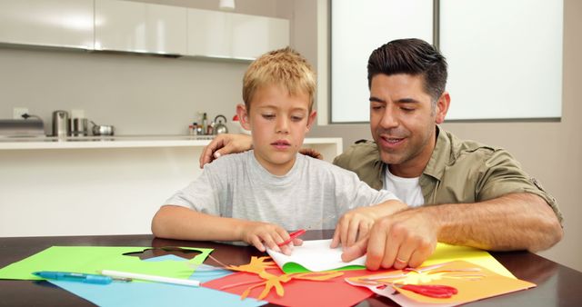 Father and Son Doing Arts and Crafts in Kitchen - Download Free Stock Images Pikwizard.com