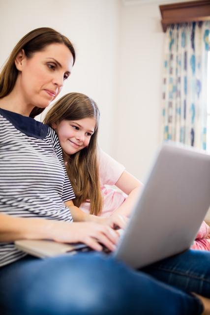 Mother and Daughter Using Laptop Together at Home - Download Free Stock Photos Pikwizard.com