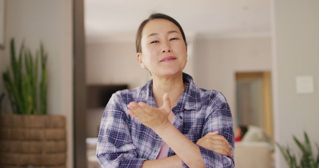 Image of happy asian woman having image call. Lifestyle, relax, spending time at home with technology concept.