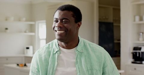 Smiling African American Man Relaxing in Modern Kitchen