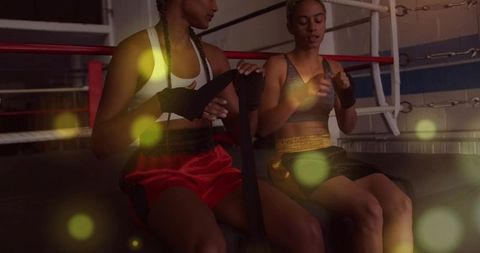 Women boxers wrapping hands on ring preparing for boxing training and sparring at gym
