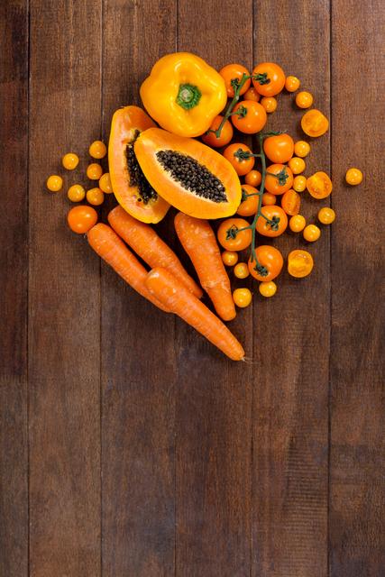 Assorted Fresh Orange Vegetables and Fruits on Wooden Table - Download Free Stock Photos Pikwizard.com
