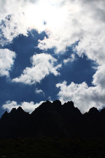Majestic Mountain Silhouette Against Dramatic Cloudscape - Download Free Stock Photos Pikwizard.com