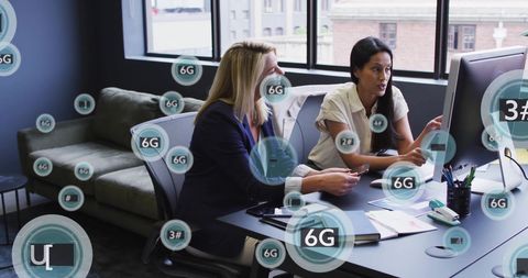 Businesswomen Collaborating in Futuristic 6G Office Environment