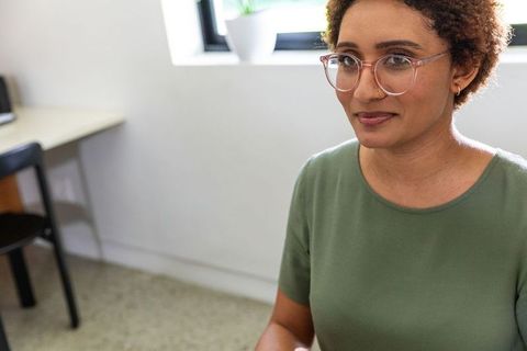 Smiling Professional Woman at Home Office Workspace