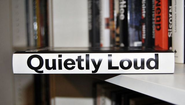 Quietly loud book spine on bookshelf with bold typography and minimal contrast