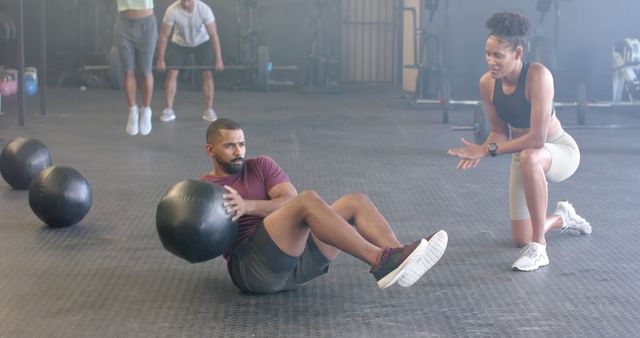 Personal Trainer Coaching Man during Core Workout with Medicine Ball - Download Free Stock Images Pikwizard.com