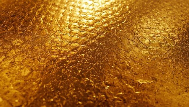 Shimmering golden metallic texture with hexagon pattern