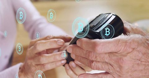 Senior couple managing bitcoin wallet on mobile device close-up hands securing crypto