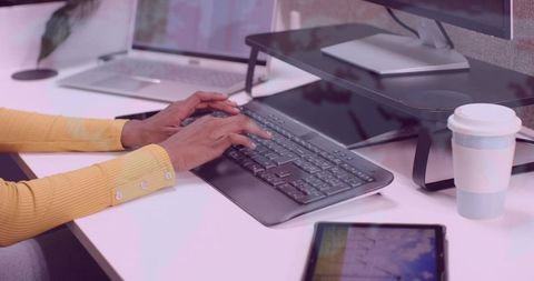 Modern Office Worker Typing for Productive Workspace Environment