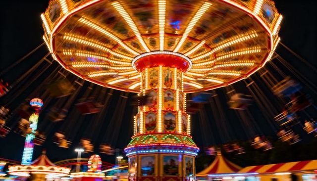 Spinning neon swing carousel creating radial light trails at night carnival festival