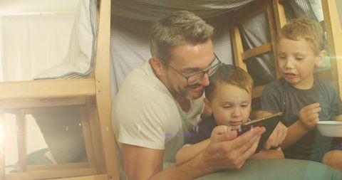 Father and Sons Bonding with Tablet in Cozy Fort