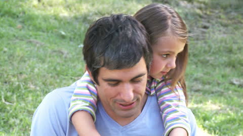 Father and Daughter Enjoying Outdoor Playtime in Park